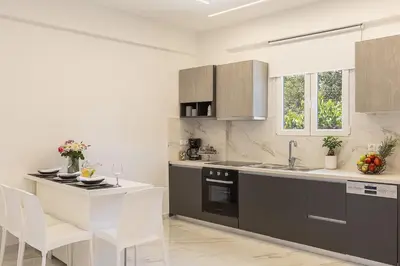 a kitchen with a sink and a stove top oven at SI-EL Villa in Vryses