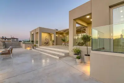 an outdoor patio of a house with chairs and plants at Villa Navelina in Mourí