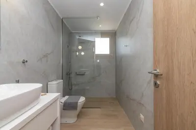 a bathroom with a toilet and a sink and a shower at Villa Navelina in Mourí