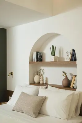 a bedroom with white walls and a bed with white pillows at Thamon lifestyle living in Chania Town