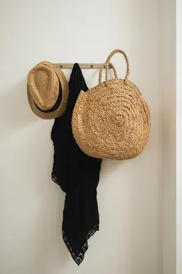 a straw hat and a bag hanging on a wall at Thamon lifestyle living in Chania Town