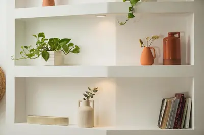 a white shelf with vases and plants on it at Thamon lifestyle living in Chania Town