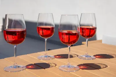four glasses of red wine sitting on a table at Ethernal Luxury Maisonette-Next to the sea in Kamisianá