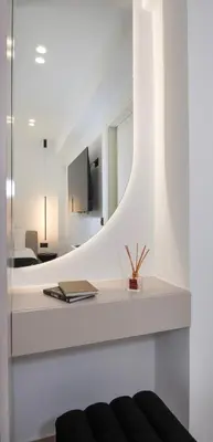 a room with a mirror and a table with a book at Ethernal Luxury Maisonette-Next to the sea in Kamisianá