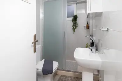 a bathroom with a sink and a toilet and a shower at Ela Apartment Chania in Chania Town