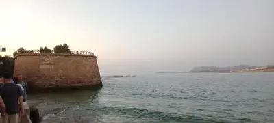 a group of people standing next to a body of water at Ela Apartment Chania in Chania Town