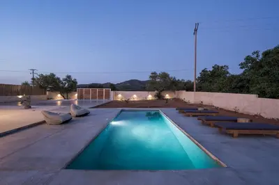 a swimming pool with several benches at Villa Zen in Alikianós