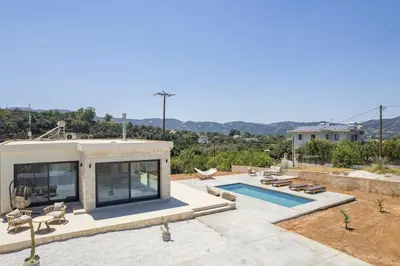 a villa with a swimming pool and a house at Villa Kumarēs in Alikianós
