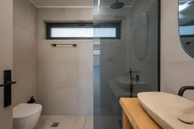 a bathroom with a shower and a toilet and a sink at Villa Kumarēs in Alikianós