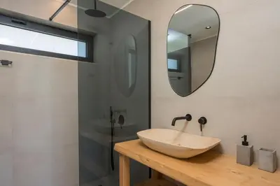 a bathroom with a sink and a mirror at Villa Kumarēs in Alikianós