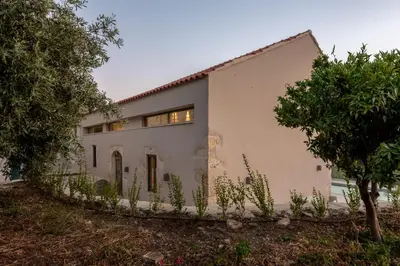a white house with trees in front of it at Olive Hideaway Private Pool Villa, Chania Sleeps 7 in Kalamitsi Amygdali