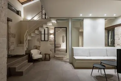 a living room with a staircase and a couch at Olive Hideaway Private Pool Villa, Chania Sleeps 7 in Kalamitsi Amygdali