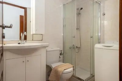 a bathroom with a toilet and a sink and a shower at Cielo y Sol in Stalos
