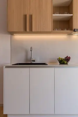 a kitchen with white cabinets and a sink at Neapolis in Chania Town