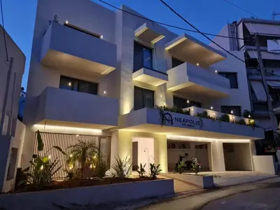 a white apartment building with lights on it at Neapolis in Chania Town