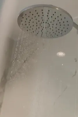 a shower with water pouring from a shower head at Neapolis in Chania Town