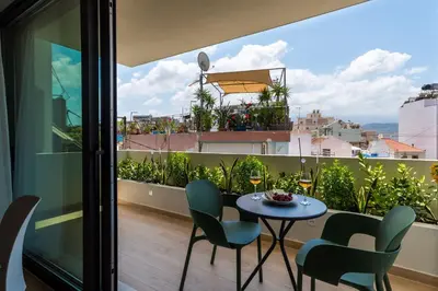 a table and chairs on a balcony with a view at Neapolis in Chania Town