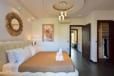 a bedroom with a bed with a stuffed animal on it at Arieldine Luxury Apartment in Chania Town