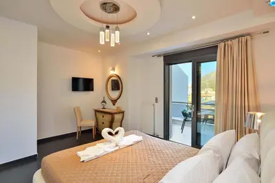 a bedroom with a bed with a heart towel on it at Arieldine Luxury Apartment in Chania Town