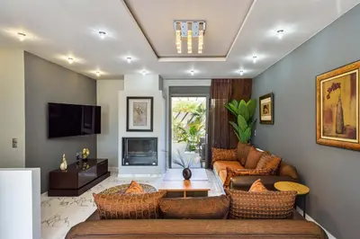 a living room with a couch and a table at Arieldine Luxury Apartment in Chania Town