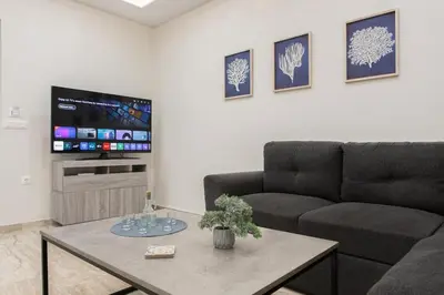 a living room with a couch and a coffee table at Yume Luxury Home in Pírgos