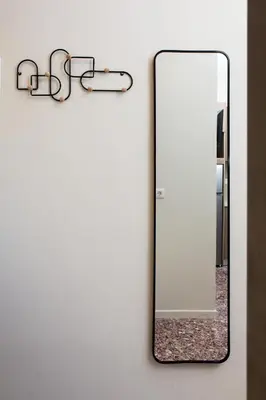 a mirror on a wall next to a bathroom at Fyllianos Apartments in Plátanos