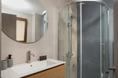 a bathroom with a sink and a shower at Fyllianos Apartments in Plátanos