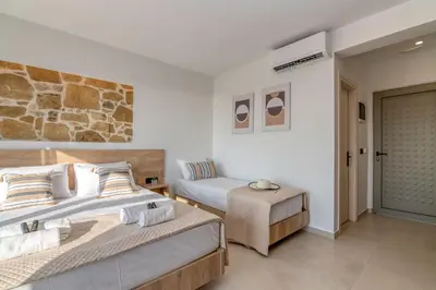 a bedroom with two beds and a couch at Elafonisi Pearl in Elafonisi