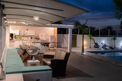 a patio with a table and chairs next to a pool at Myrto Villa heated pool in Kato Daratso