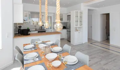 a dining room and kitchen with a table and chairs at Myrto Villa heated pool in Kato Daratso