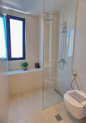 a bathroom with a shower and a toilet at Melina Apartments Sea & City in Chania Town