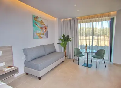 a living room with a couch and a table at Melina Apartments Sea & City in Chania Town