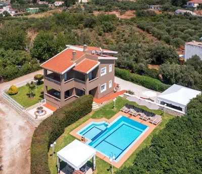 an aerial view of a house with a swimming pool at Villa Clio, with Mountain view in Arménoi