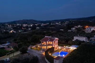 an aerial view of a house with a swimming pool at Villa Clio, with Mountain view in Arménoi