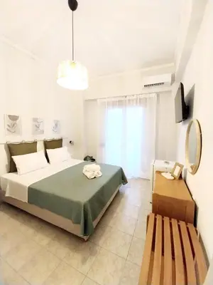a bedroom with a bed and a bench in it at Lithos in Palaiochóra