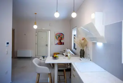a kitchen with a table and chairs in a room at Maira City House in Chania Town