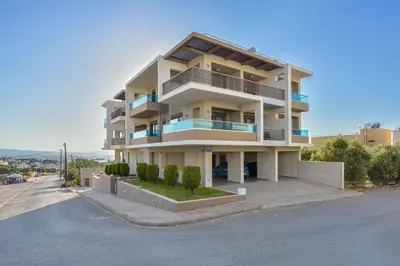 a large apartment building with balconies on a street at Marena Apartments in Chania Town