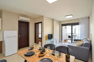 a kitchen and living room with a table and chairs at Marena Apartments in Chania Town