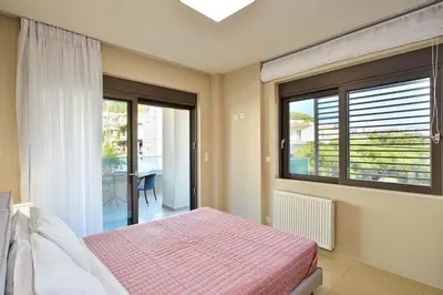 a bedroom with a bed and a large window at Marena Apartments in Chania Town