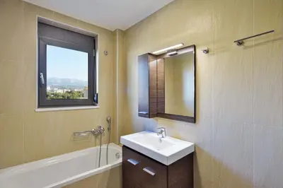 a bathroom with a sink and a mirror and a window at Marena Apartments in Chania Town
