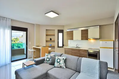 a living room with a couch and a kitchen at Marena Apartments in Chania Town
