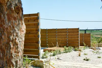 a wooden fence in the middle of a field at LIViT Condo Elafonisi in Agios Padeleimon