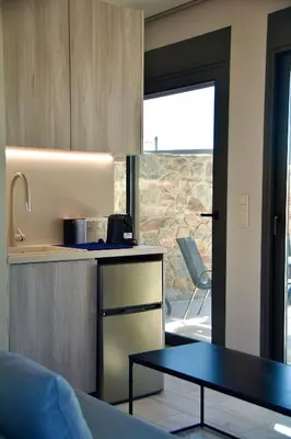 a kitchen with a counter and a table in a room at LIViT Condo Elafonisi in Agios Padeleimon