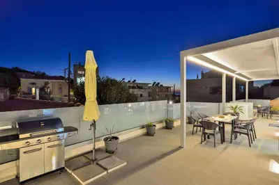 a patio with an umbrella and a table and chairs at Artemis Luxury Home in Chania Town