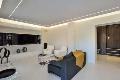 a living room with a blue couch and a tv at Artemis Luxury Home in Chania Town