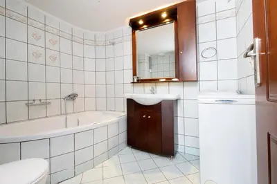 a bathroom with a tub and a sink and a toilet at Nektar Luxury Apartment in Stalos