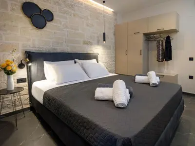 a bedroom with a large bed with two towels at PanStel - Villa Aurora with private pool jacuzzi in Ayiá
