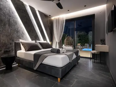 a bedroom with a king sized bed and a television at PanStel - Villa Aurora with private pool jacuzzi in Ayiá