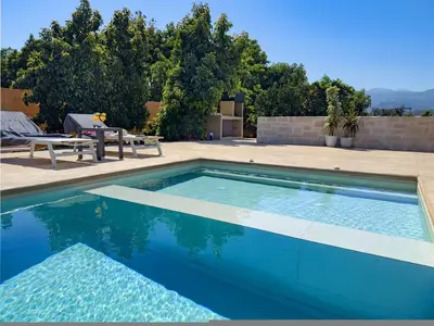 a swimming pool with a table and a picnic table at PanStel - Villa Aurora with private pool jacuzzi in Ayiá