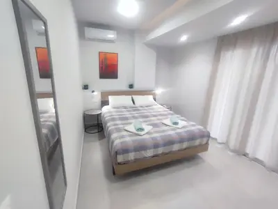 a small bedroom with a bed and a mirror at MC Luxury Living in Chania Town